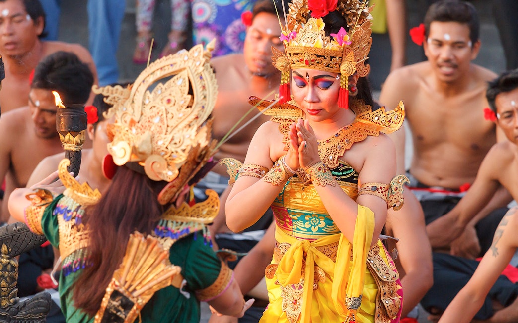 Balinese dancers in traditional attire performing a cultural dance in Bali, Indonesia.