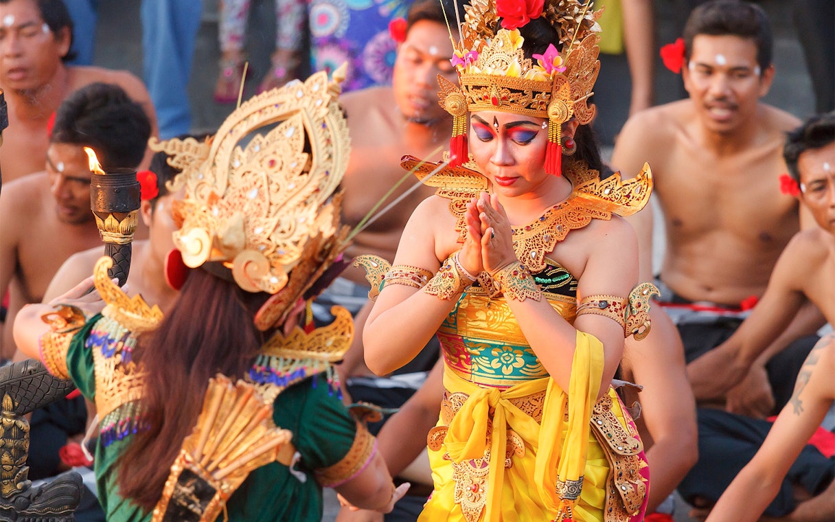 Balinese dancers in traditional attire performing a cultural dance in Bali, Indonesia.