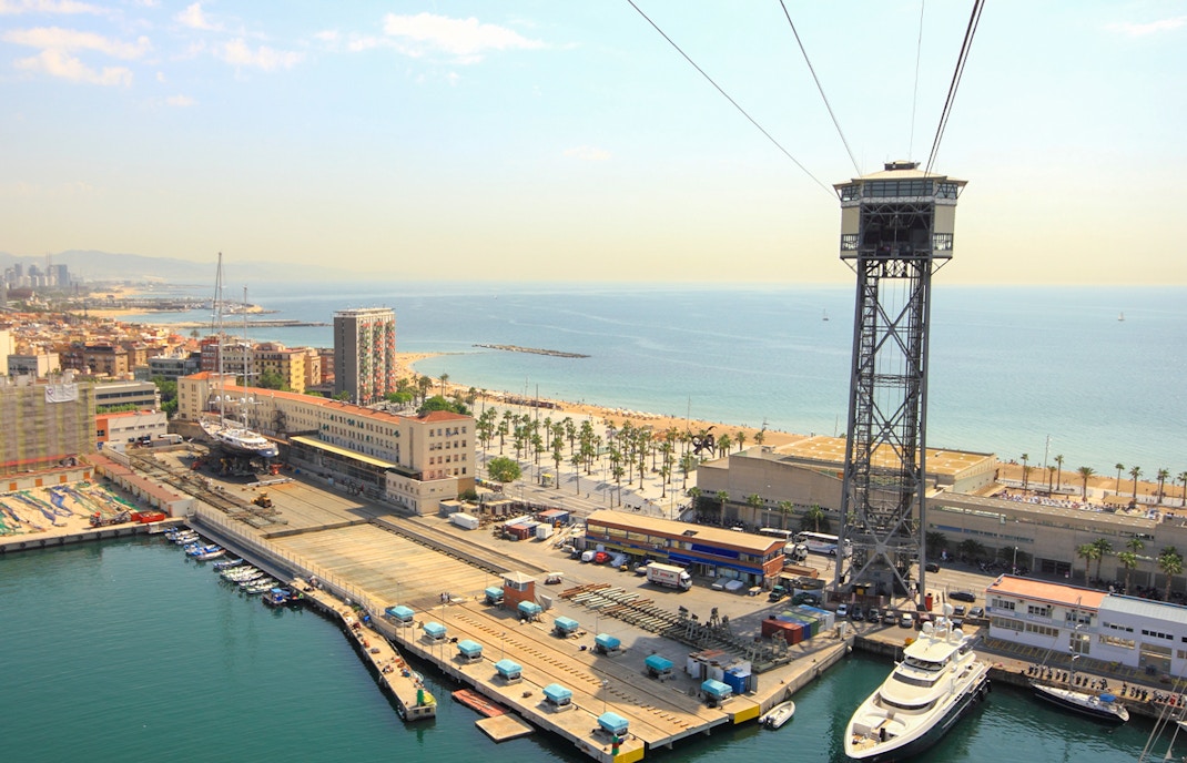 Montjuic Cable Car overlooking Barcelona cityscape and Aquarium Barcelona entrance.