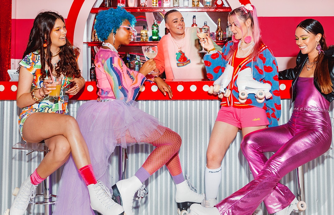 Roller skaters enjoying drinks at Amsterdam Roller Dreams Skating Rink bar.