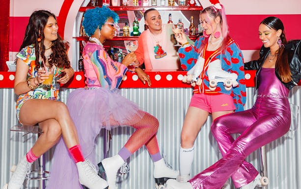 Roller skaters enjoying drinks at Amsterdam Roller Dreams Skating Rink bar.