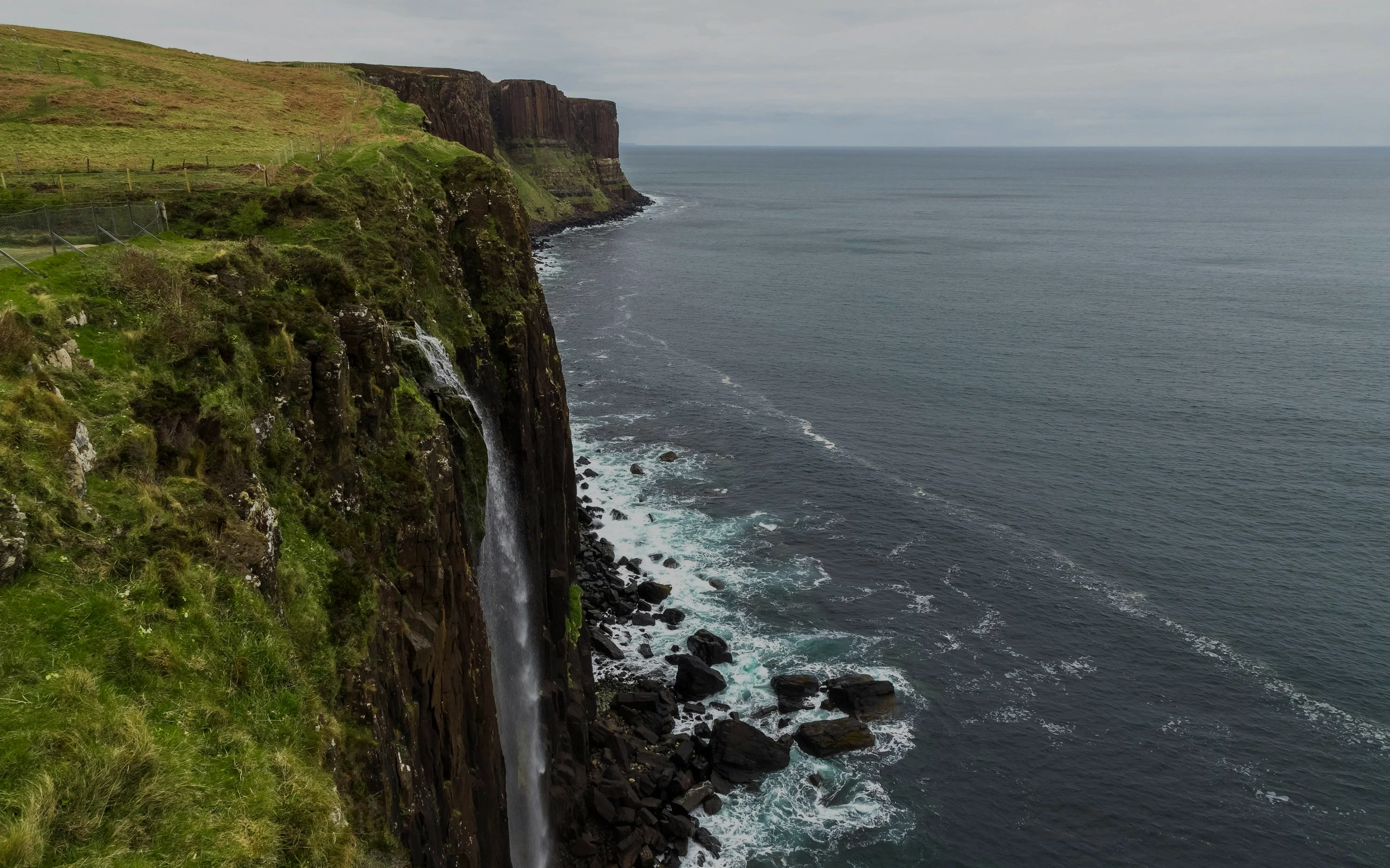 Kilt Rock waterfall cascading into the sea on the Isle of Skye, Scotland.