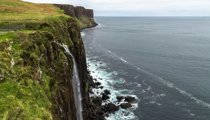 Kilt Rock waterfall cascading into the sea on the Isle of Skye, Scotland.