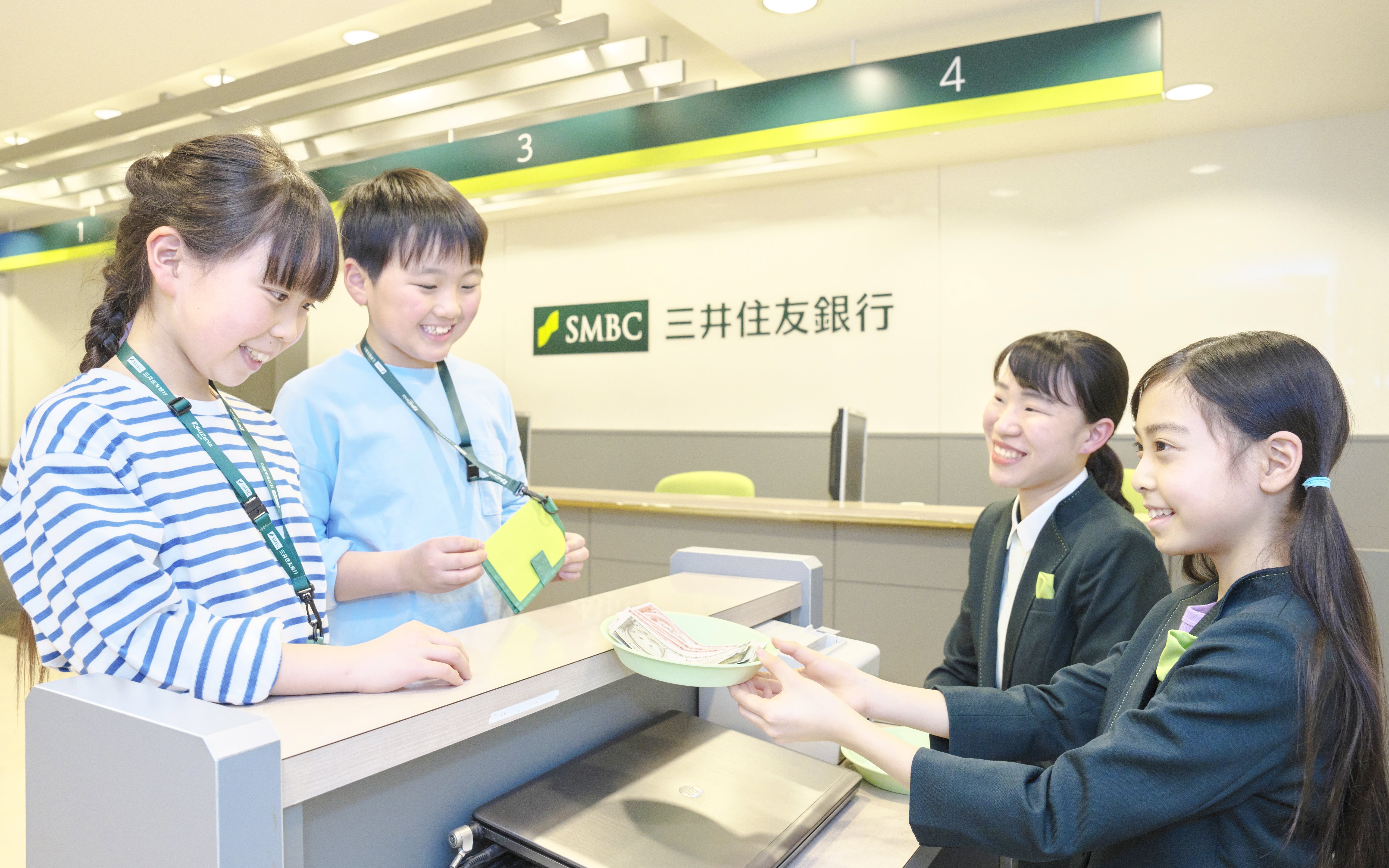 Children role-playing as bank tellers at KidZania Tokyo.