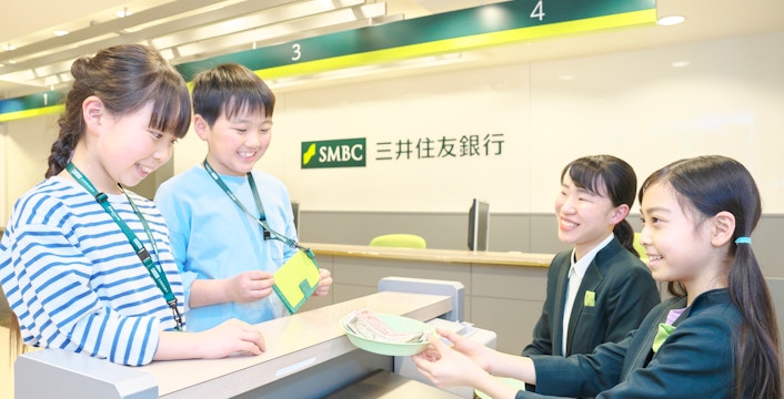 Children role-playing as bank tellers at KidZania Tokyo.