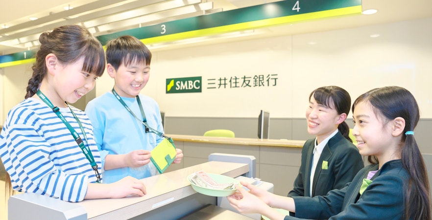 Children role-playing as bank tellers at KidZania Tokyo.