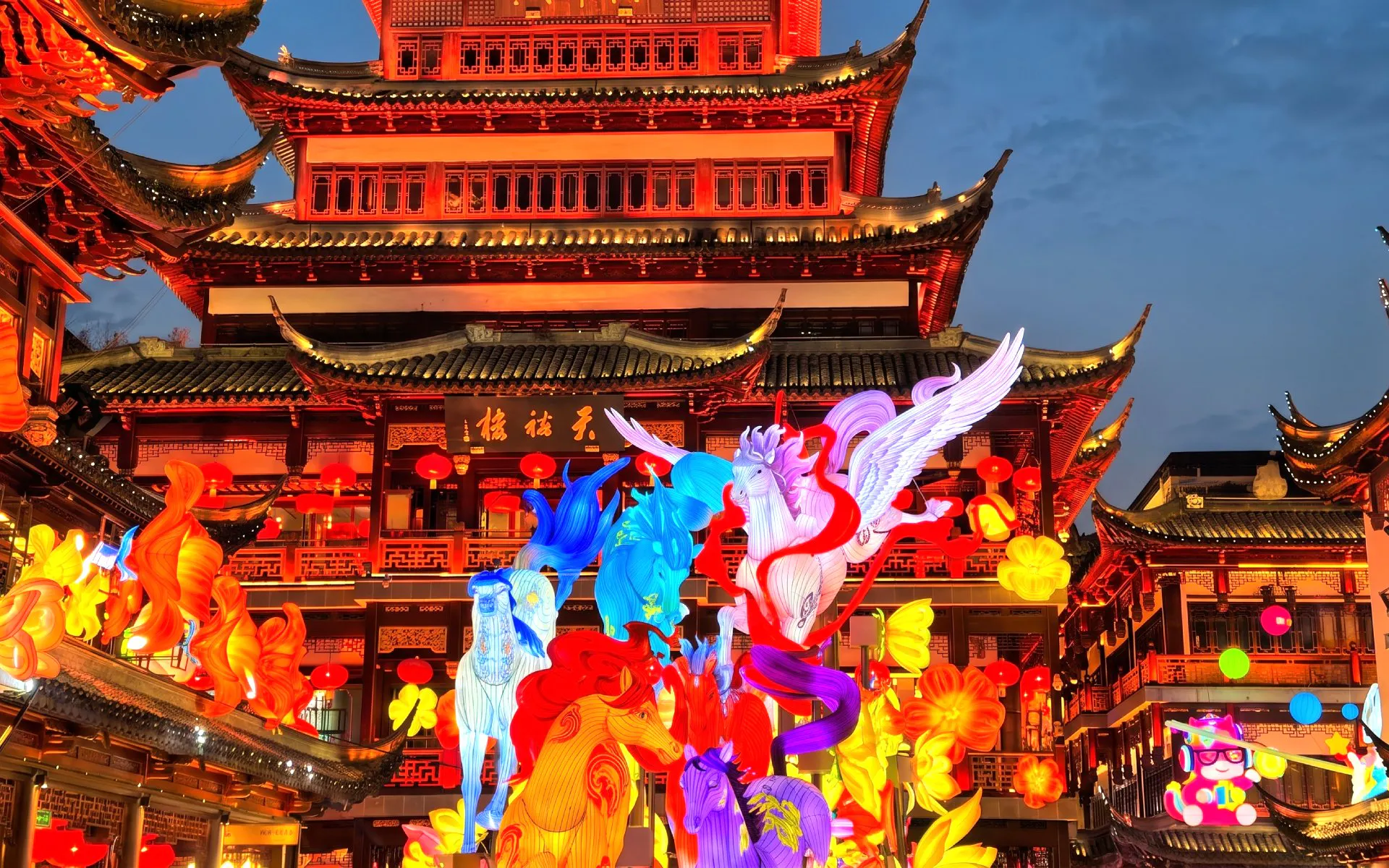 Lantern display at Yu Garden, Shanghai, featuring colorful mythical creatures and traditional architecture.