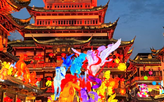 Lantern display at Yu Garden, Shanghai, featuring colorful mythical creatures and traditional architecture.