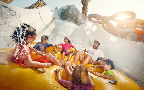 People enjoying Falcons Falaj water ride at YAS Waterworld, Abu Dhabi.