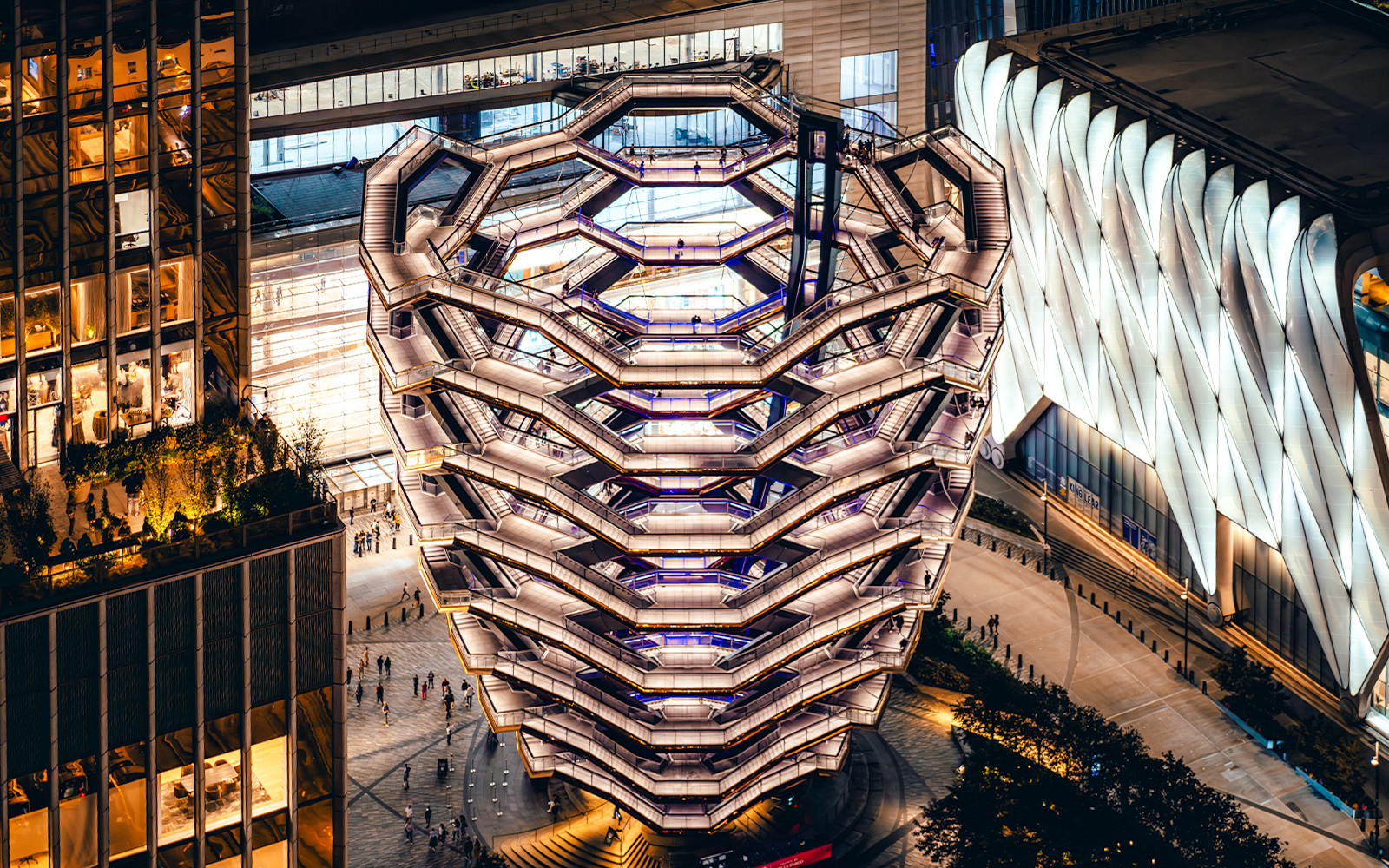 Vessel structure in New York City illuminated at night, viewed from above.