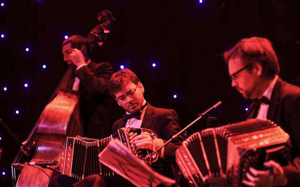 Musicians performing tango at El Viejo Almacén with bandoneons and double bass.