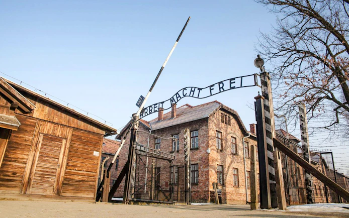 Entrance gate with "Arbeit Macht Frei" sign at Auschwitz I concentration camp, Poland.
