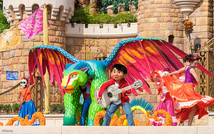 Coco float with colorful characters and performers at Disneyland Hong Kong parade.