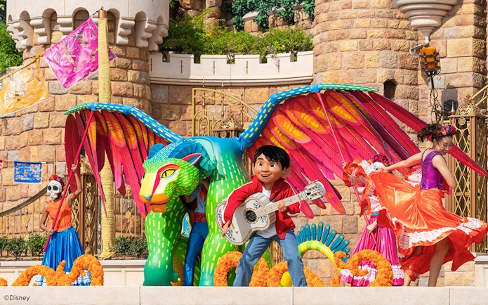 Coco float with colorful characters and performers at Disneyland Hong Kong parade.