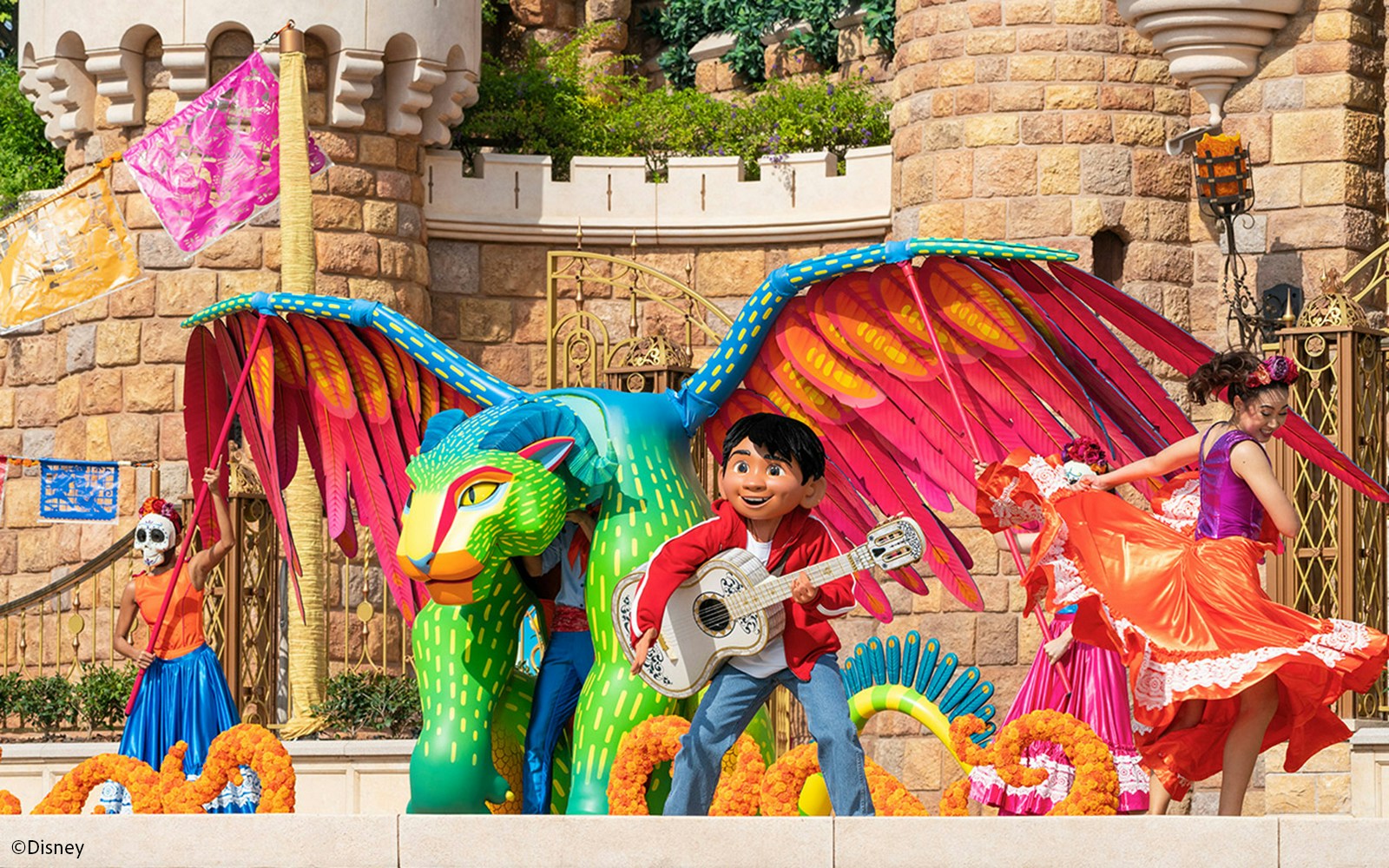 Coco float with colorful characters and performers at Disneyland Hong Kong parade.