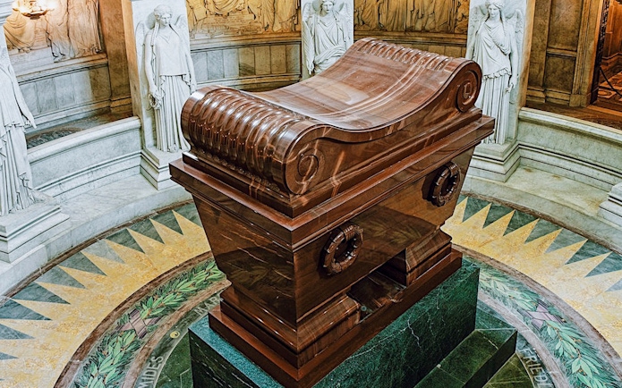Napoleon Bonaparte’s tomb in Les Invalides, Paris, surrounded by marble statues.