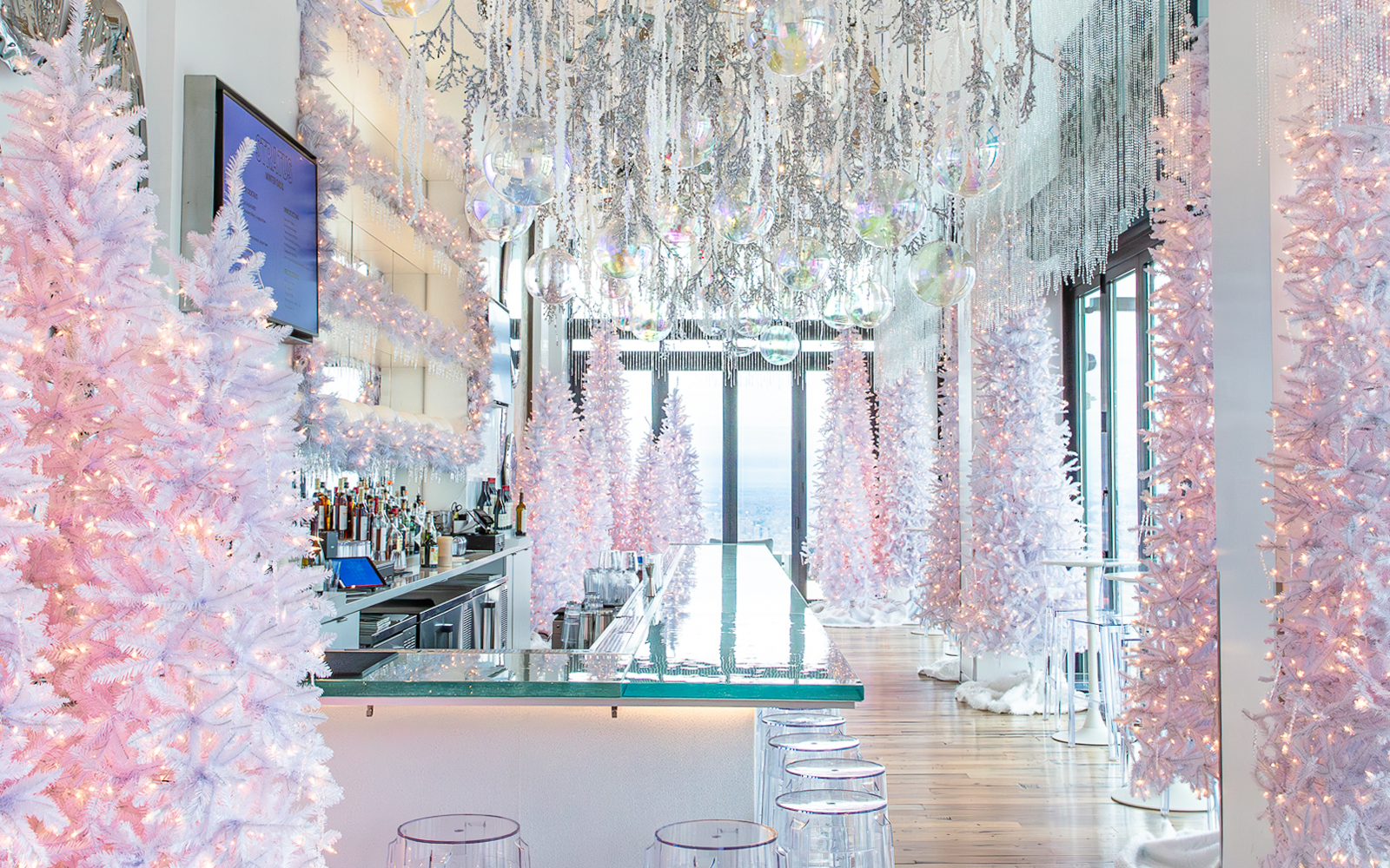 Winter-themed bar with white trees and lights at View Boston.