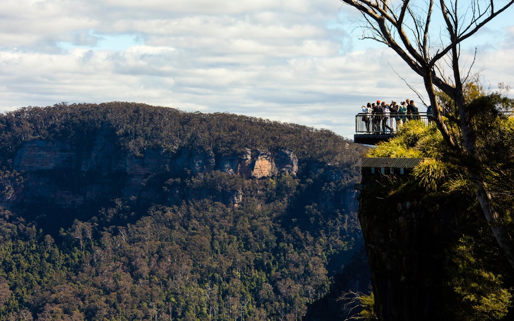 Visitors on a lookout at Echo Point with view of Three Sisters, Blue Mountains, Australia.