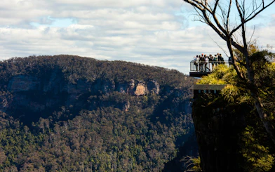 Visitors on a lookout at Echo Point with view of Three Sisters, Blue Mountains, Australia.