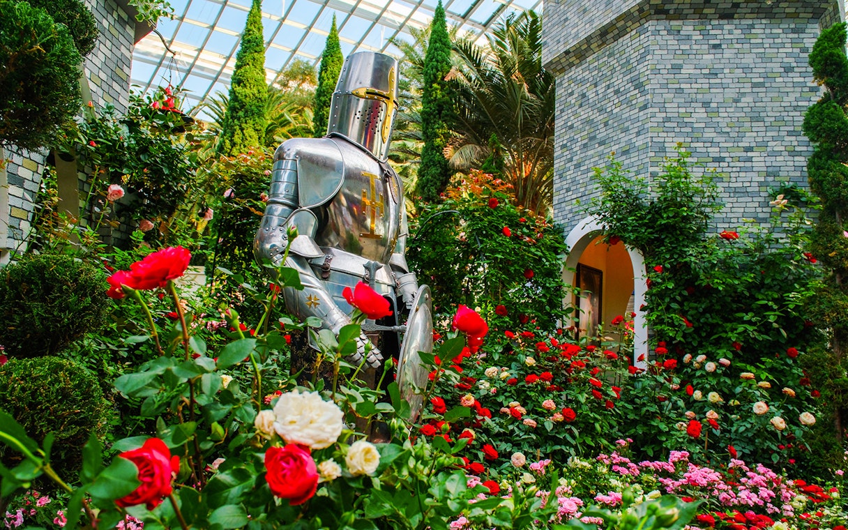 Knight statue surrounded by roses at Gardens by the Bay Flower Dome, Singapore.