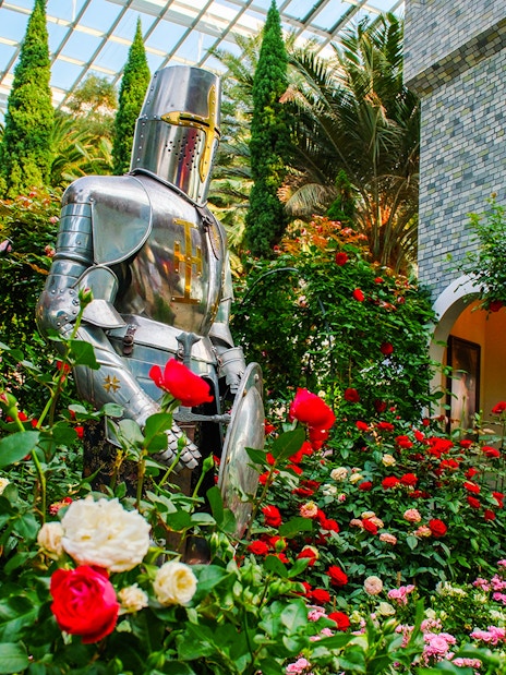 Knight statue surrounded by roses at Gardens by the Bay Flower Dome, Singapore.