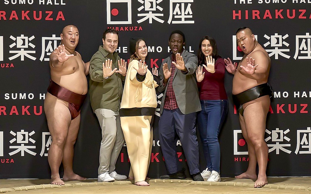 Sumo wrestlers and visitors posing at Sumo Hall Hirakuza Osaka.