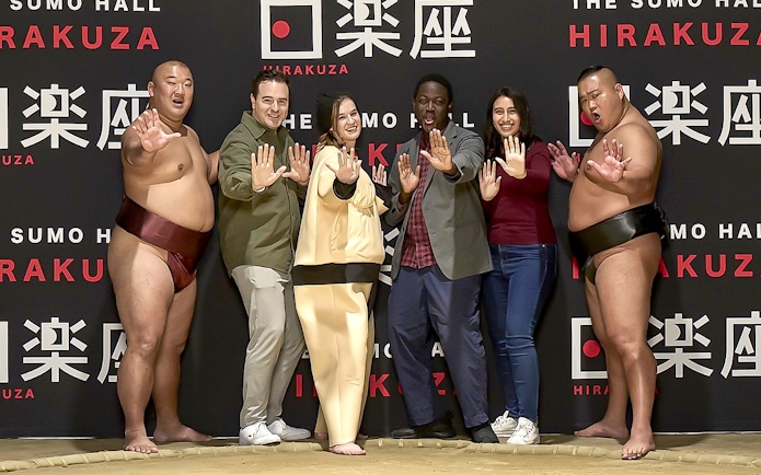 Sumo wrestlers and visitors posing at Sumo Hall Hirakuza Osaka.