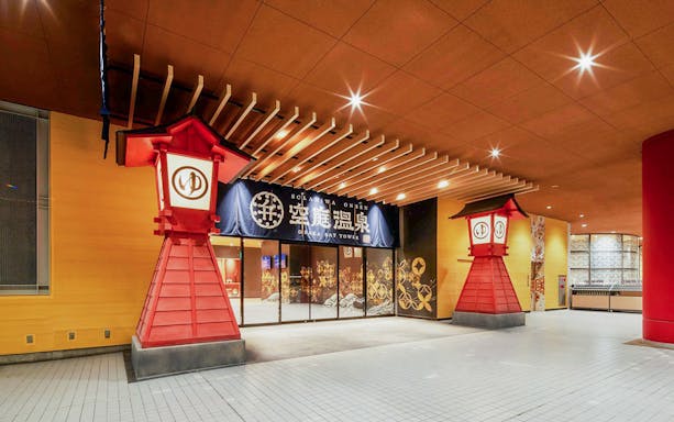 Entrance of Solaniwa Onsen with traditional red lanterns, Osaka Bay Tower.