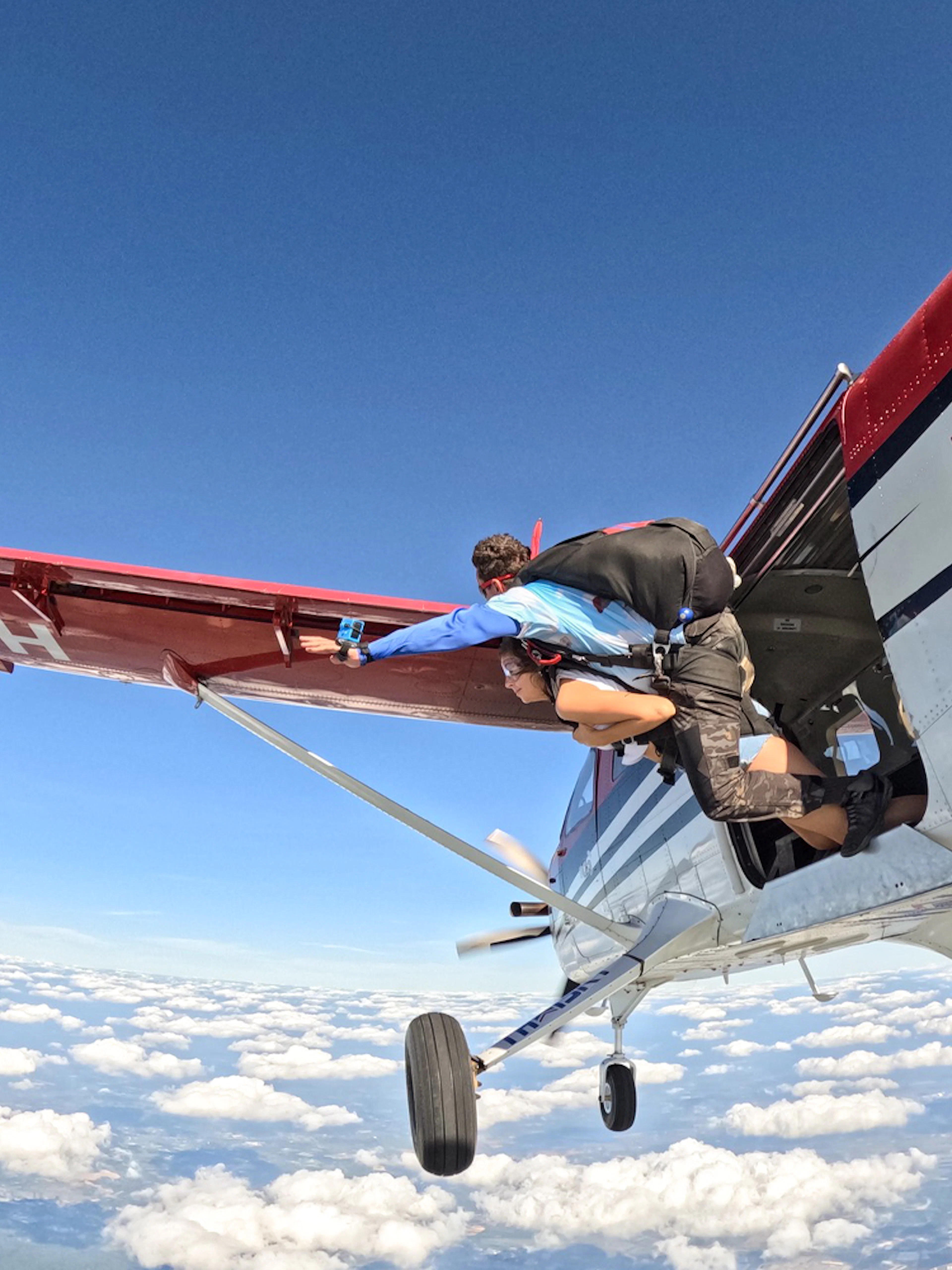 Tandem skydivers exiting plane over Pattaya at 13,000 feet.