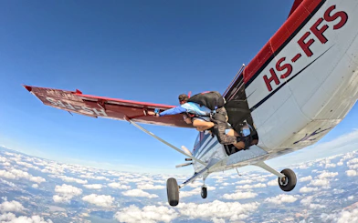 Tandem skydivers exiting plane over Pattaya at 13,000 feet.