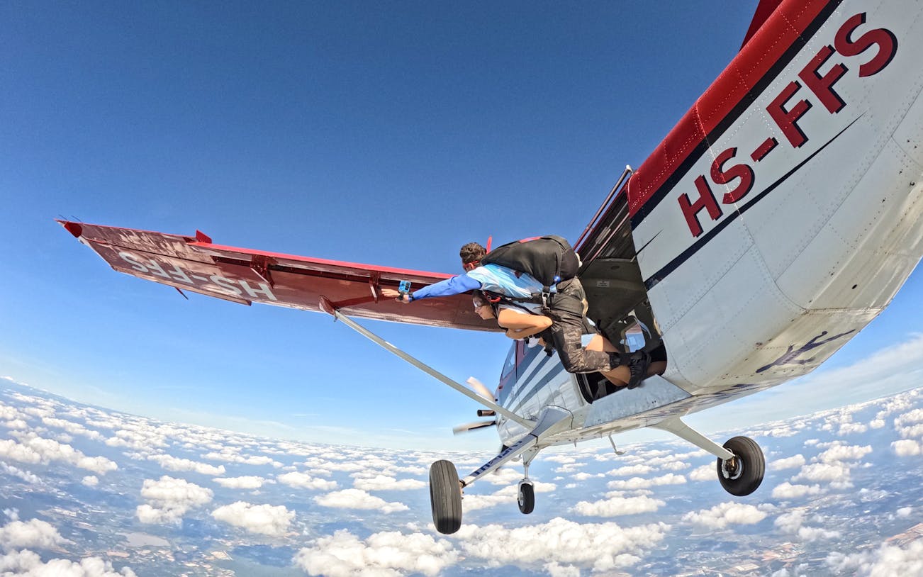 Tandem skydivers exiting plane over Pattaya at 13,000 feet.
