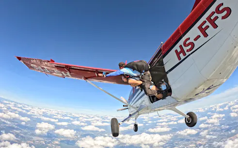 Tandem skydivers exiting plane over Pattaya at 13,000 feet.