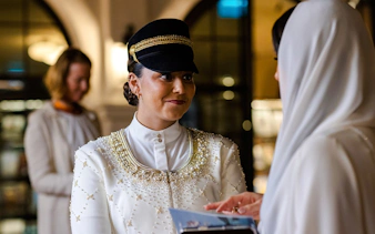 Guide in traditional attire during Abu Dhabi Royal Equestrian Arts tour.