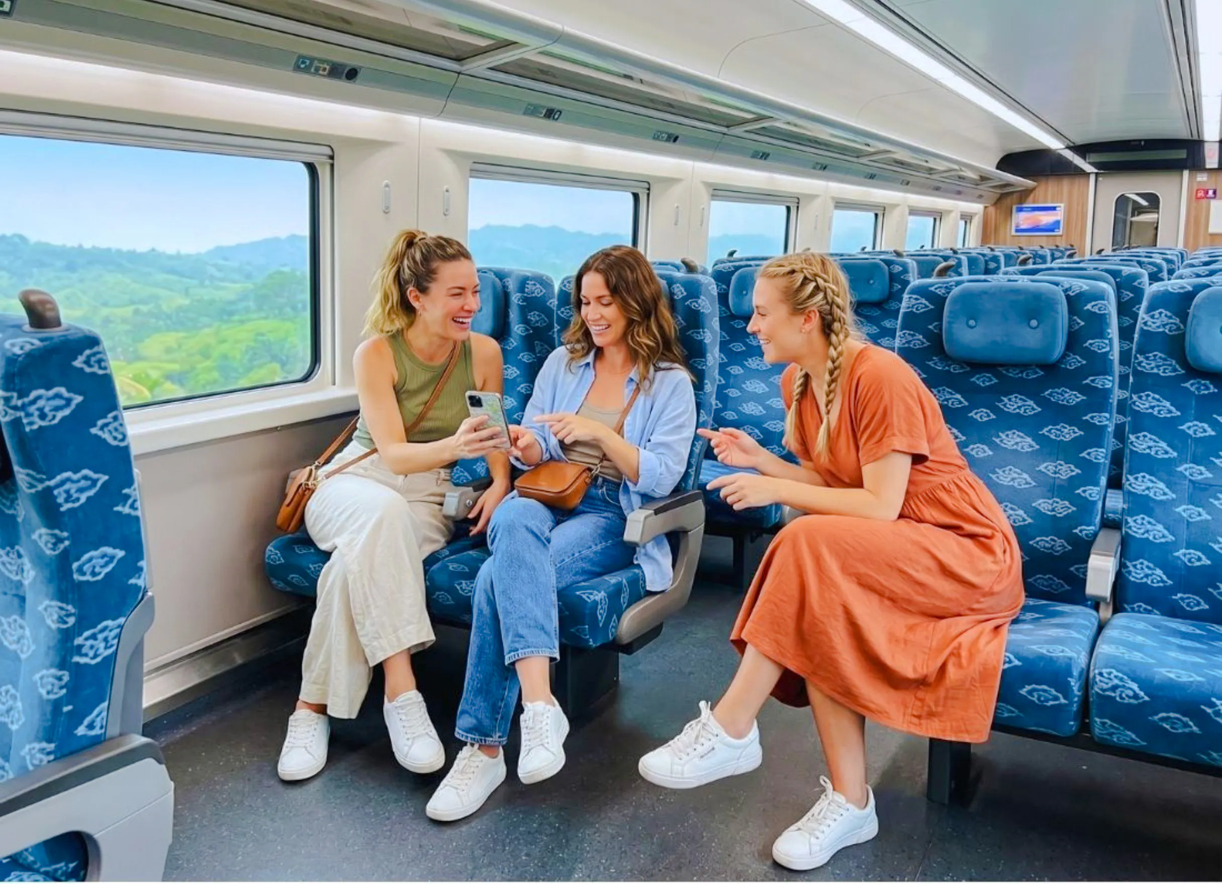 Travelers enjoying a train ride from Jakarta to Bandung with scenic views outside.