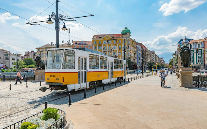 Tram passing by Lion's Bridge in Sofia during a city exploration game.