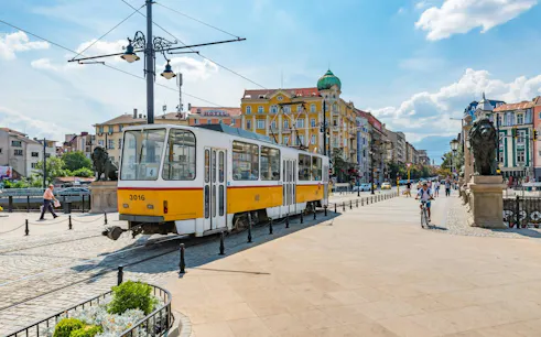 Tram passing by Lion's Bridge in Sofia during a city exploration game.