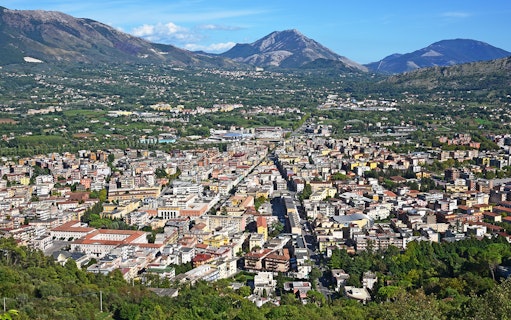 Aerial view of a town with mountains in the background on the Amalfi & Positano tour from Rome.