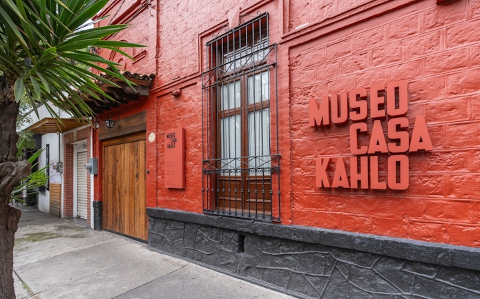 Museo Casa Kahlo entrance with red brick facade in Mexico City.