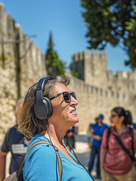 Visitor enjoying audio tour at St. George Castle, Lisbon.