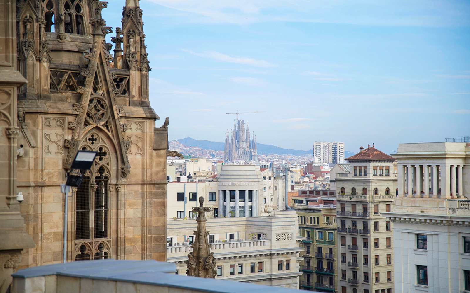 Barcelona Cathedral terrace view with Sagrada Familia in the distance.