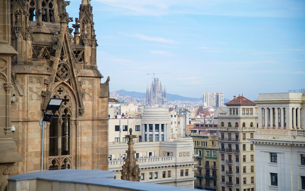 Barcelona Cathedral terrace view with Sagrada Familia in the distance.