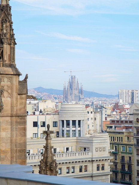 Barcelona Cathedral terrace view with Sagrada Familia in the distance.