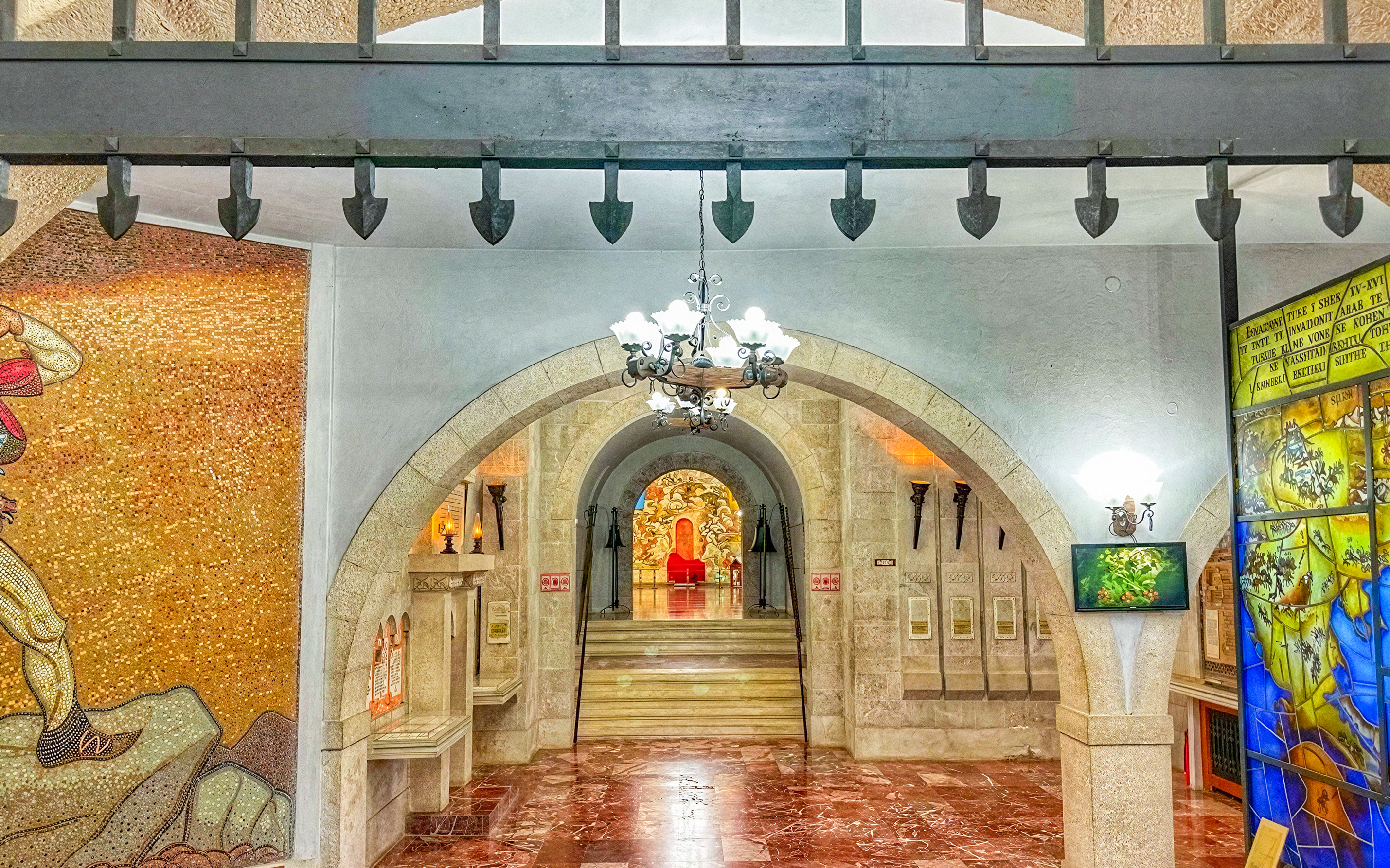 Interior of Skanderbeg Museum in Kruja Castle, Albania, featuring arches and historical mosaics.