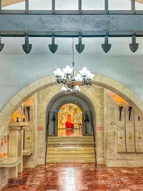 Interior of Skanderbeg Museum in Kruja Castle, Albania, featuring arches and historical mosaics.