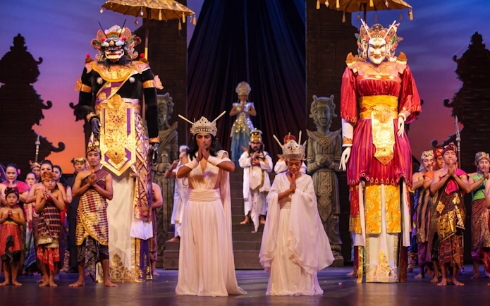 Balinese cultural performance with traditional costumes and large puppets at Bali Safari.