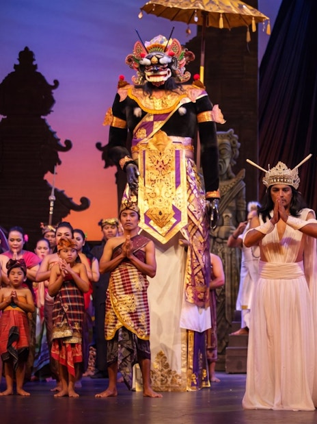 Balinese cultural performance with traditional costumes and large puppets at Bali Safari.