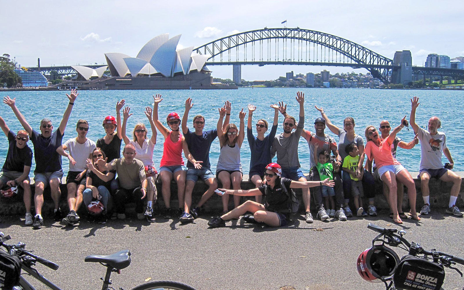 Group enjoying Bonza Bike Tours with Sydney Opera House and Harbour Bridge in background.