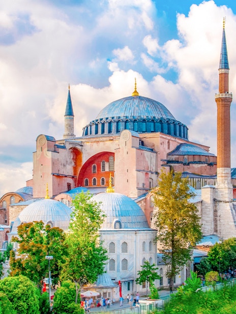 Hagia Sophia exterior with minarets in Istanbul, surrounded by greenery.