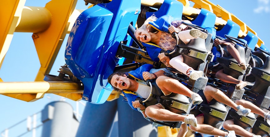 Friends enjoying a thrilling rollercoaster ride at an amusement park.