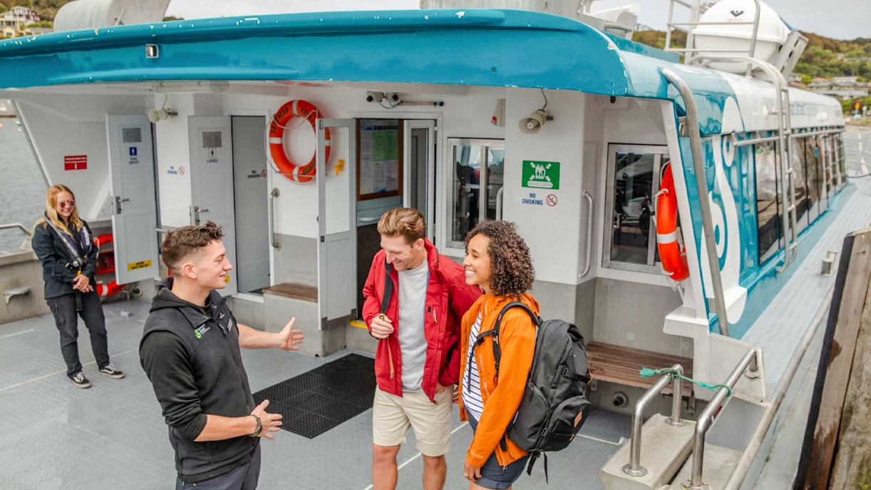 Crew assisting tourists boarding the Stewart Island Ferry.